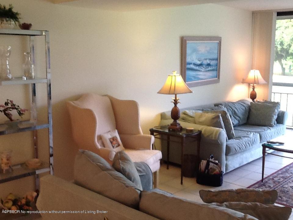 6157 Balboa Circle, Unit 206 Boca Raton, FL 33433 - Photo 6 of 31 a living room with furniture and a lamp