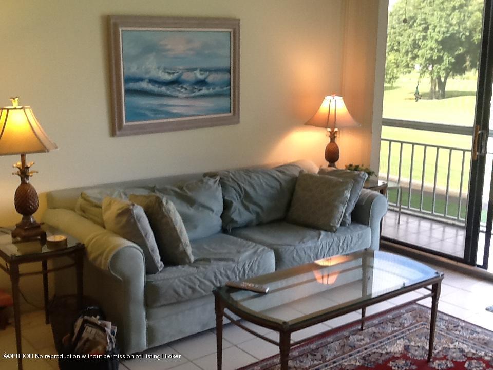 6157 Balboa Circle, Unit 206 Boca Raton, FL 33433 - Photo 7 of 31 a living room with furniture a lamp and a potted plant