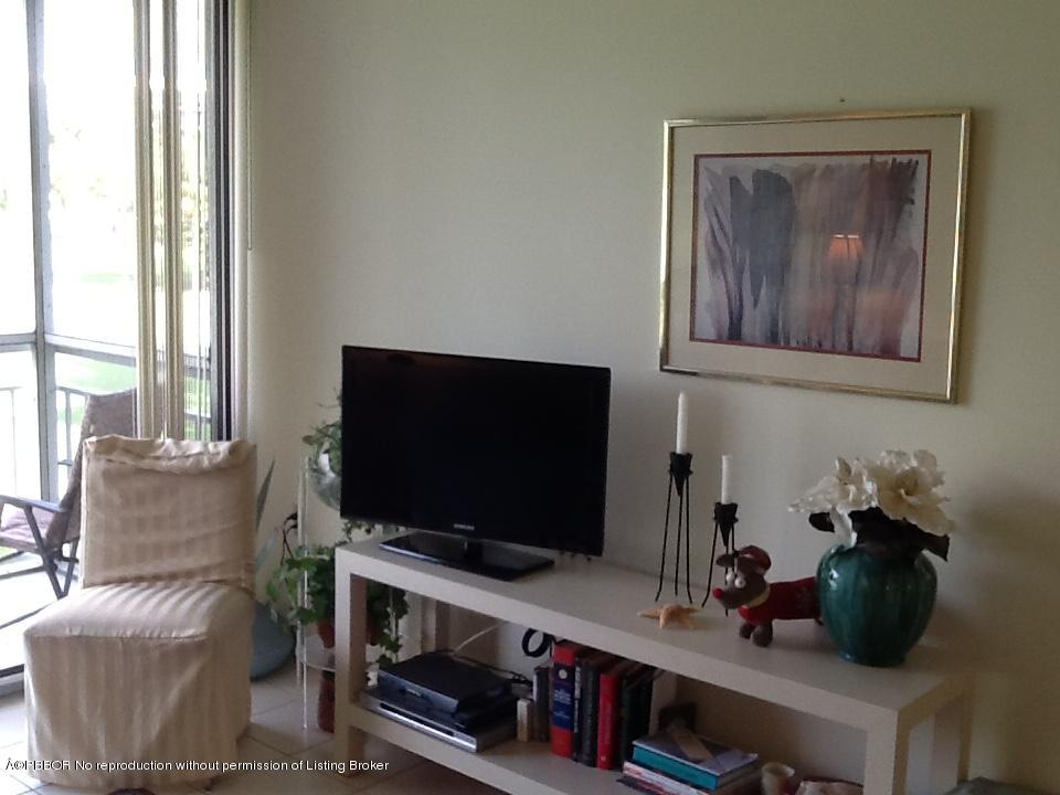 6157 Balboa Circle, Unit 206 Boca Raton, FL 33433 - Photo 8 of 31 a living room with furniture and a flat screen tv