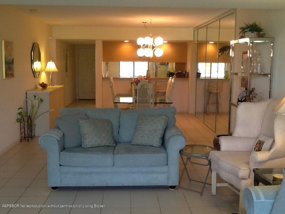 6157 Balboa Circle, Unit 206 Boca Raton, FL 33433 - Photo 9 of 31 a living room with furniture and a chandelier