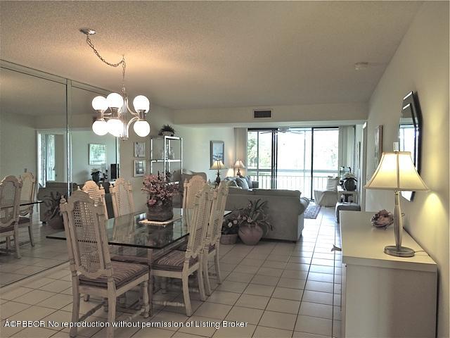 6157 Balboa Circle, Unit 206 Boca Raton, FL 33433 - Photo 10 of 31 a view of a dining room with furniture and chandelier