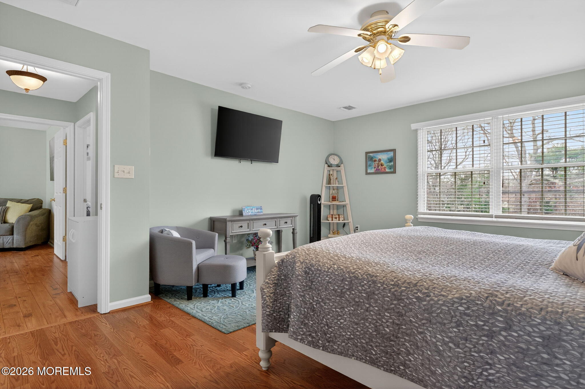 520 Hardenberg Avenue Point Pleasant, NJ 08742 - Photo 22 of 36 a spacious bedroom with a bed a chair and a chandelier