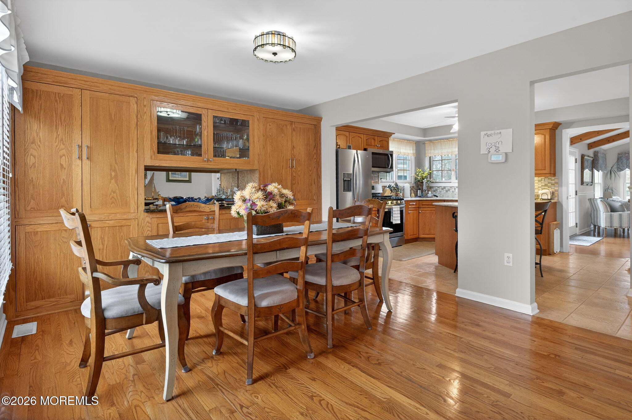 520 Hardenberg Avenue Point Pleasant, NJ 08742 - Photo 3 of 36 a dining room with wooden floor a glass table and chairs