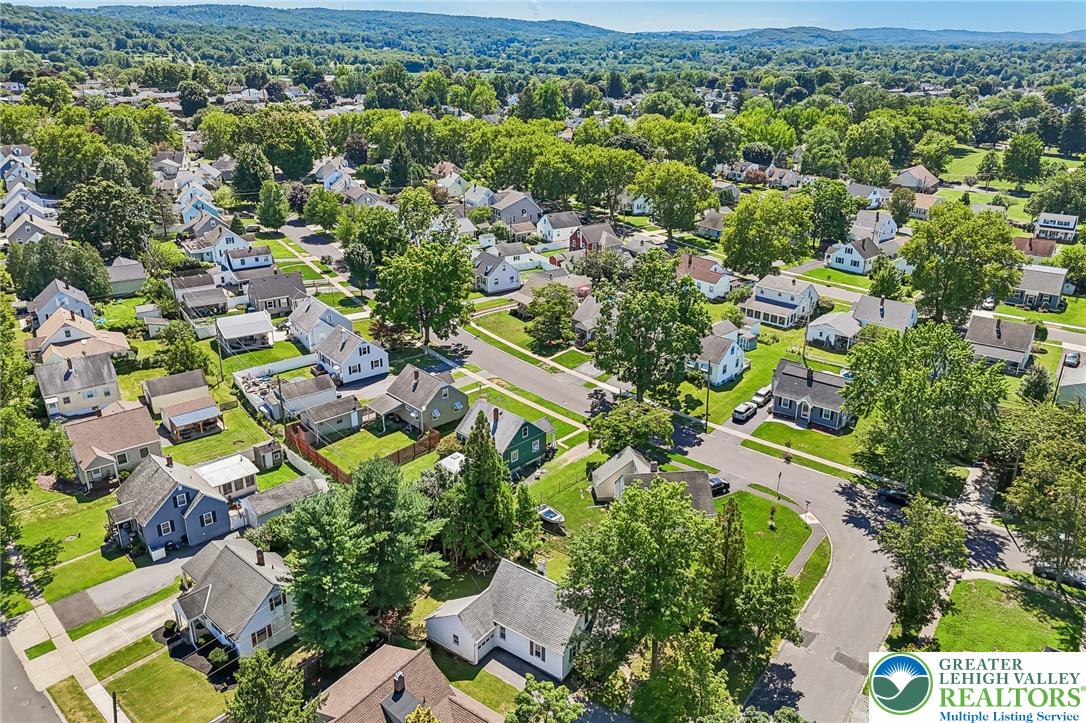 974 Juniper Road Hellertown, PA 18055 - Photo 41 of 48 An aerial perspective showcases an established neighborhood with homes nestled among mature trees.