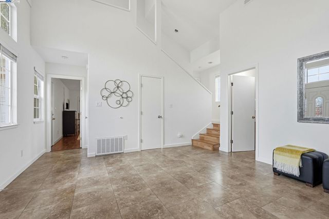 a living room with furniture wooden floor and windows