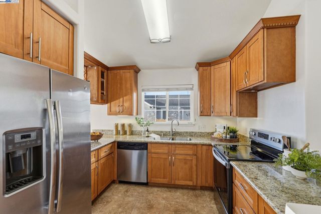 a kitchen with granite countertop a sink and a window
