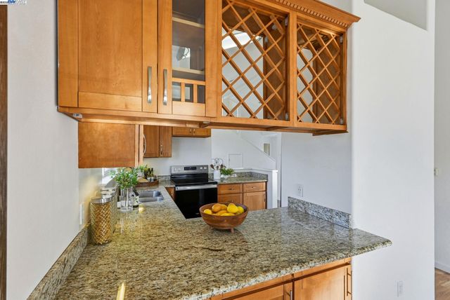 a kitchen that has a sink and a stove in it