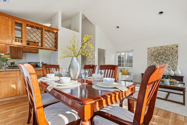 a living room with furniture a flat screen tv and a table
