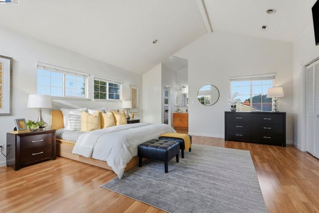 a bedroom with bed and wooden floor