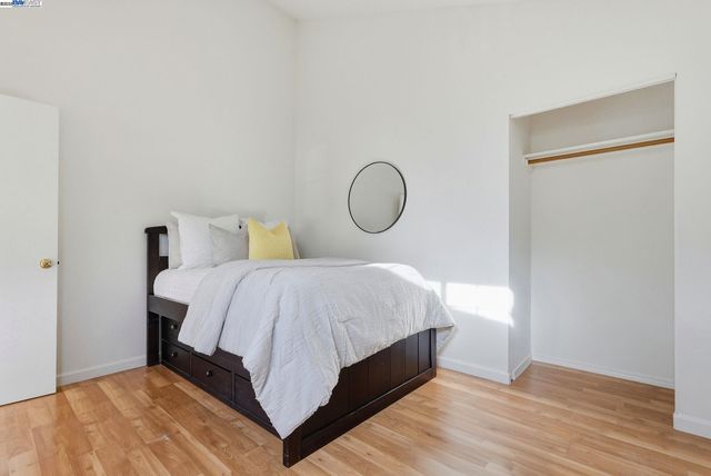 a bathroom with a granite countertop sink a toilet a mirror and shower