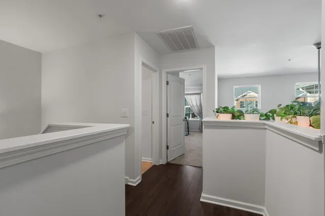 a hallway with sink and wooden floor