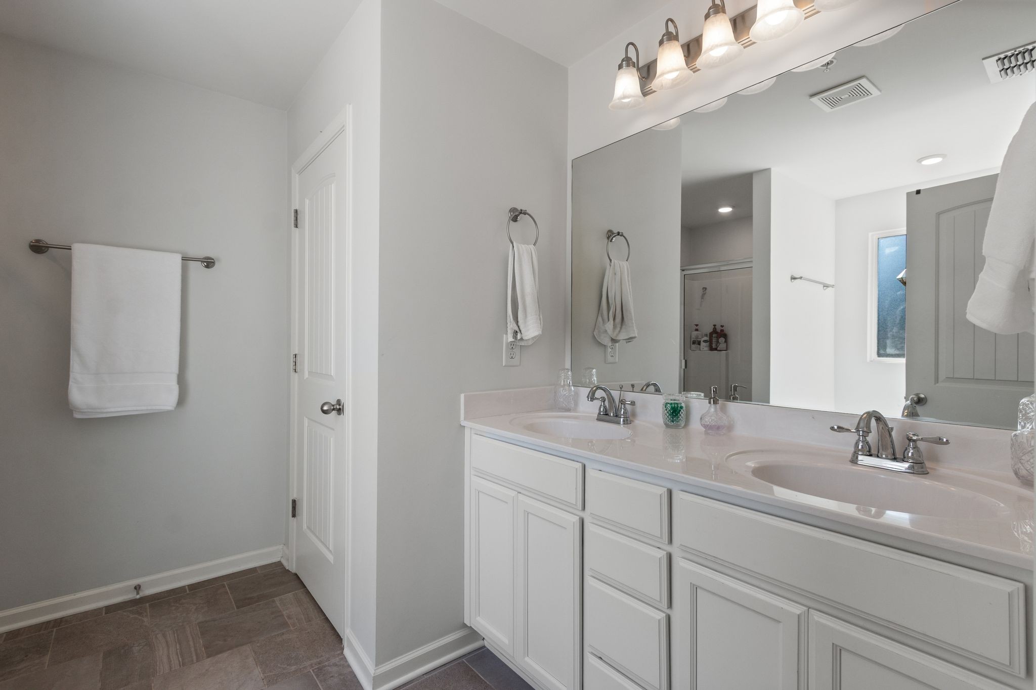 1002 Muna Court Spring Hill, TN 37174 - Photo 20 of 28 a bathroom with a double vanity sink and a mirror