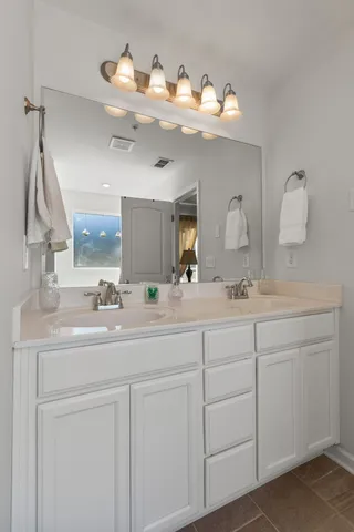 a bathroom with a sink vanity and mirror