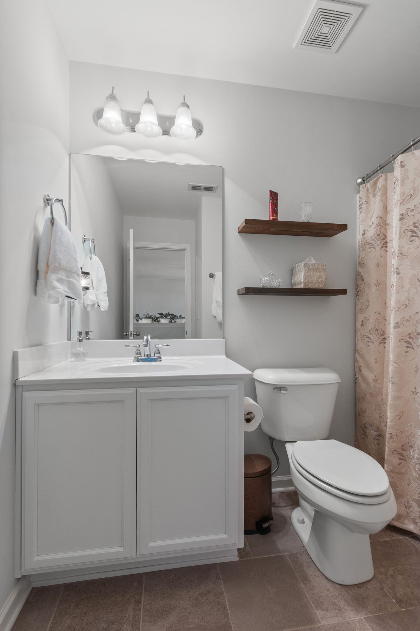 1002 Muna Court Spring Hill, TN 37174 - Photo 26 of 28 a bathroom with a sink vanity mirror and toilet