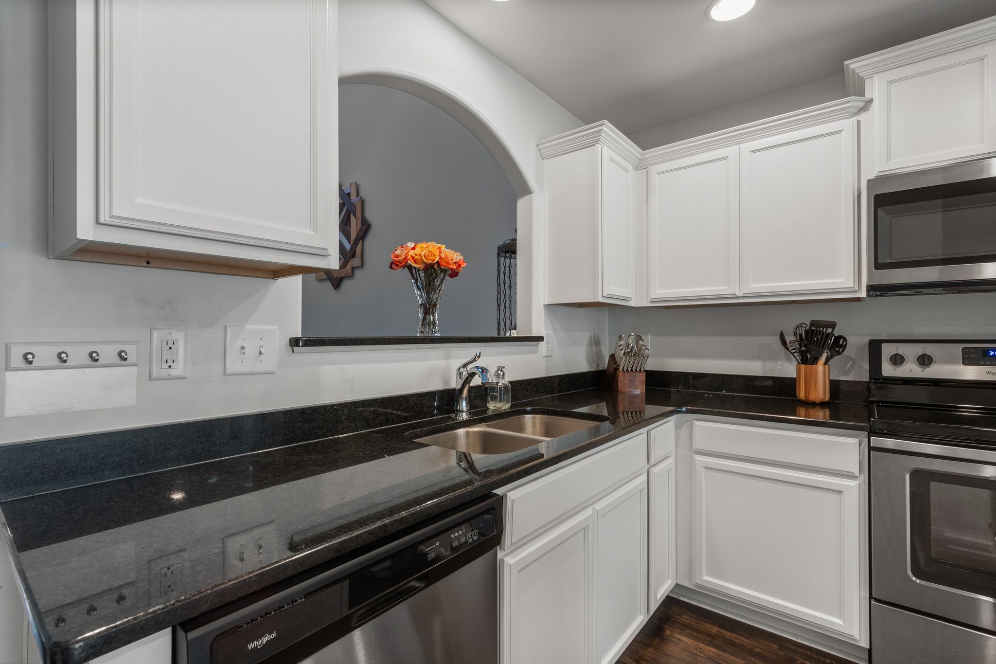 1002 Muna Court Spring Hill, TN 37174 - Photo 8 of 28 a kitchen with stainless steel appliances a sink stove and microwave