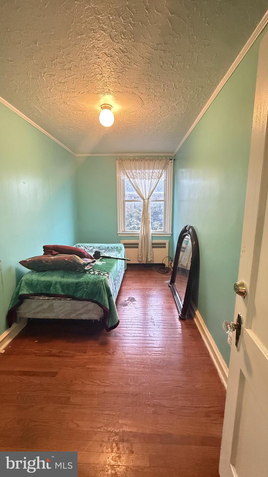 6135 Castor Avenue Philadelphia, PA 19149 - Photo 3 of 44 a bedroom with furniture and a wooden floor
