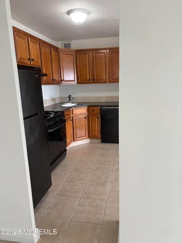 a kitchen with a refrigerator stove and sink