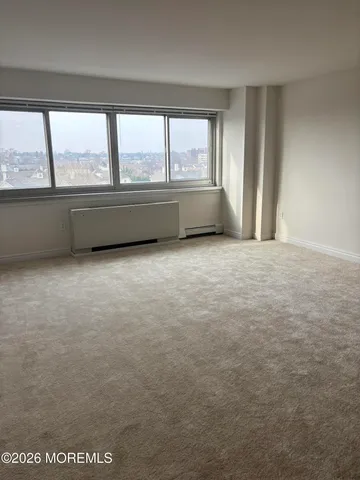 an empty room with large windows