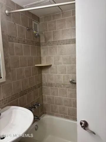 a bathroom with a bathtub and shower