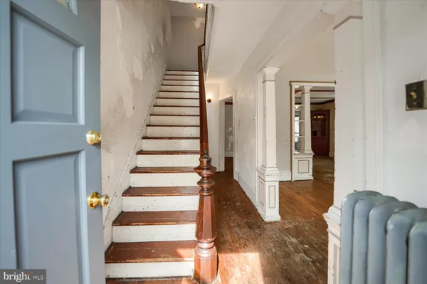 a view of entryway and hall with wooden floor