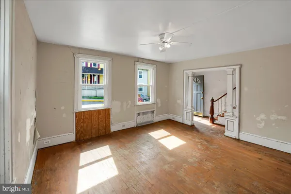 wooden floor in an empty room with a window