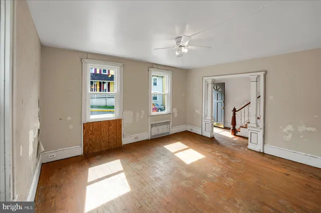 wooden floor in an empty room with a window