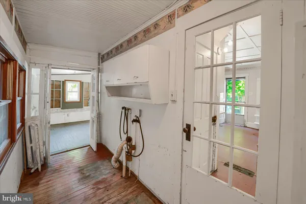 a view of a room with wooden floor and windows