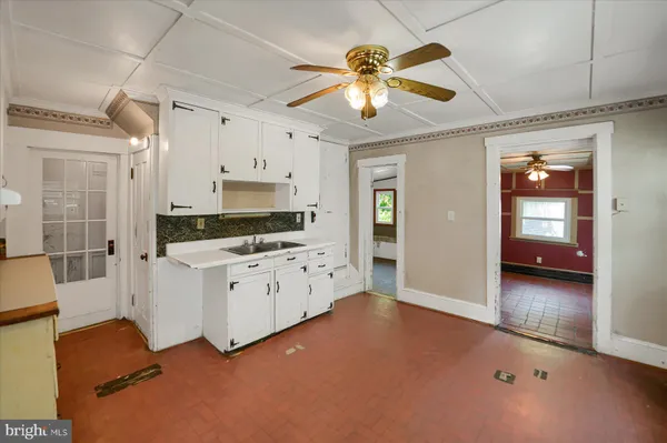 a view of a kitchen with cabinet and a chandelier fan