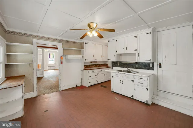 a kitchen with white cabinets and white appliances