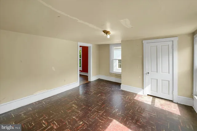 wooden floor in an empty room with a window