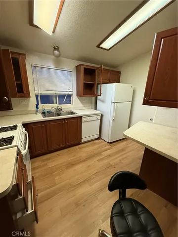a kitchen with a sink appliances and cabinets
