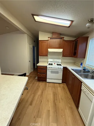 a kitchen with a stove a sink and a refrigerator