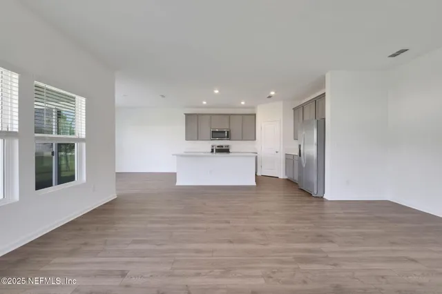 a view of a kitchen with a sink and cabinets