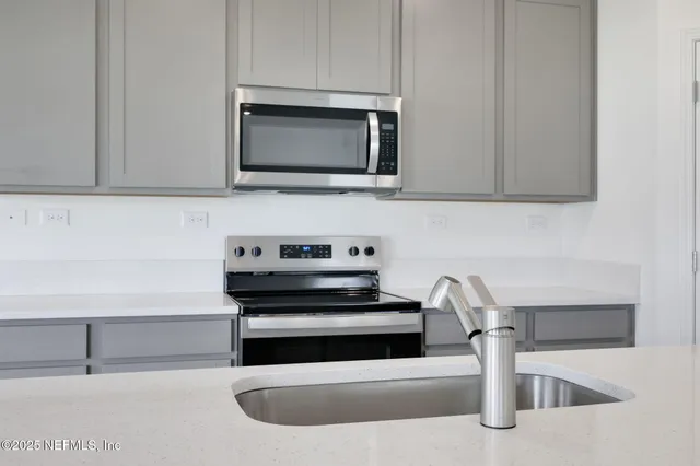 a kitchen with a stove and a microwave