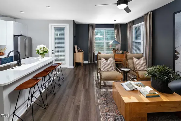 a living room with furniture and a wooden floor