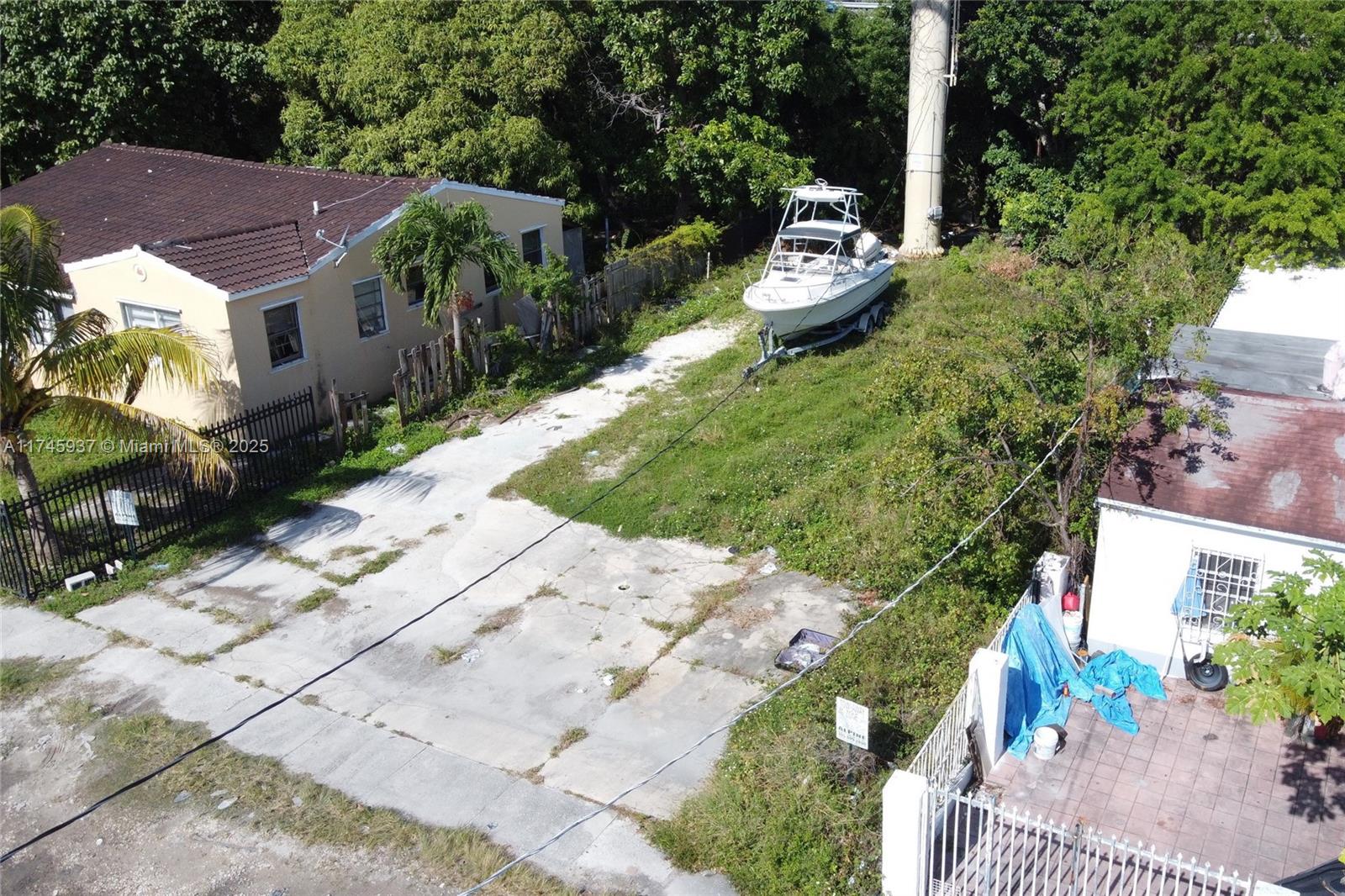 321 Northwest 37th Street Miami, FL 33127 - Photo 17 of 49 a backyard of a house with a yard and outdoor seating