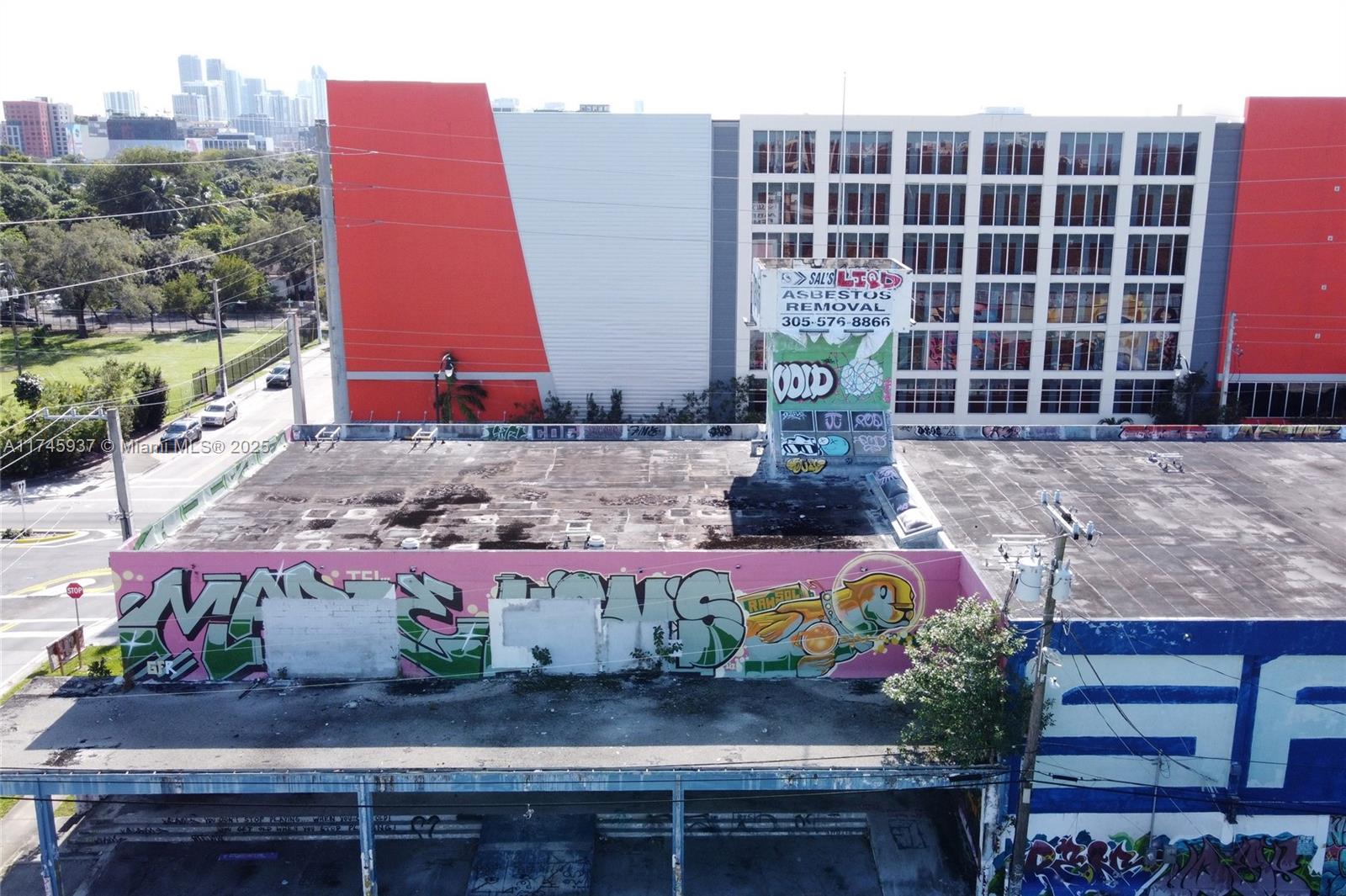 321 Northwest 37th Street Miami, FL 33127 - Photo 26 of 49 a front view of multi story residential apartment building with yard