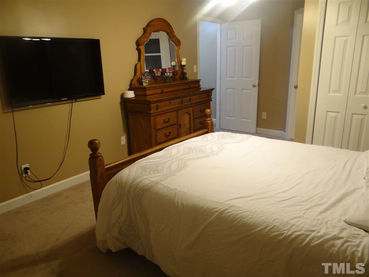 4208 Wolftrap Road Raleigh, NC 27616 - Photo 15 of 23 a bedroom with a bed and a television
