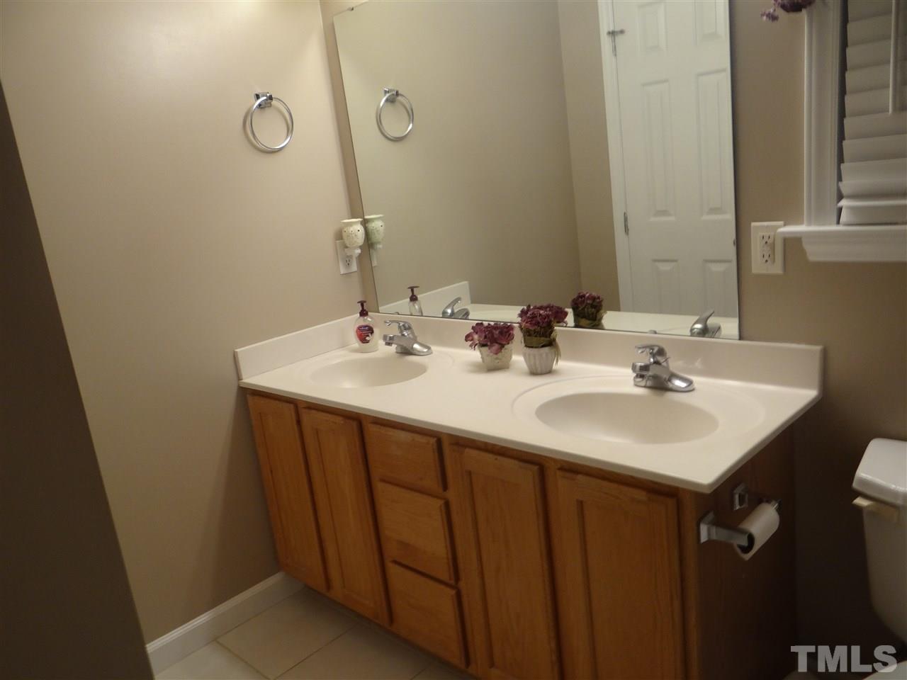 4208 Wolftrap Road Raleigh, NC 27616 - Photo 18 of 23 a bathroom with a sink and a mirror
