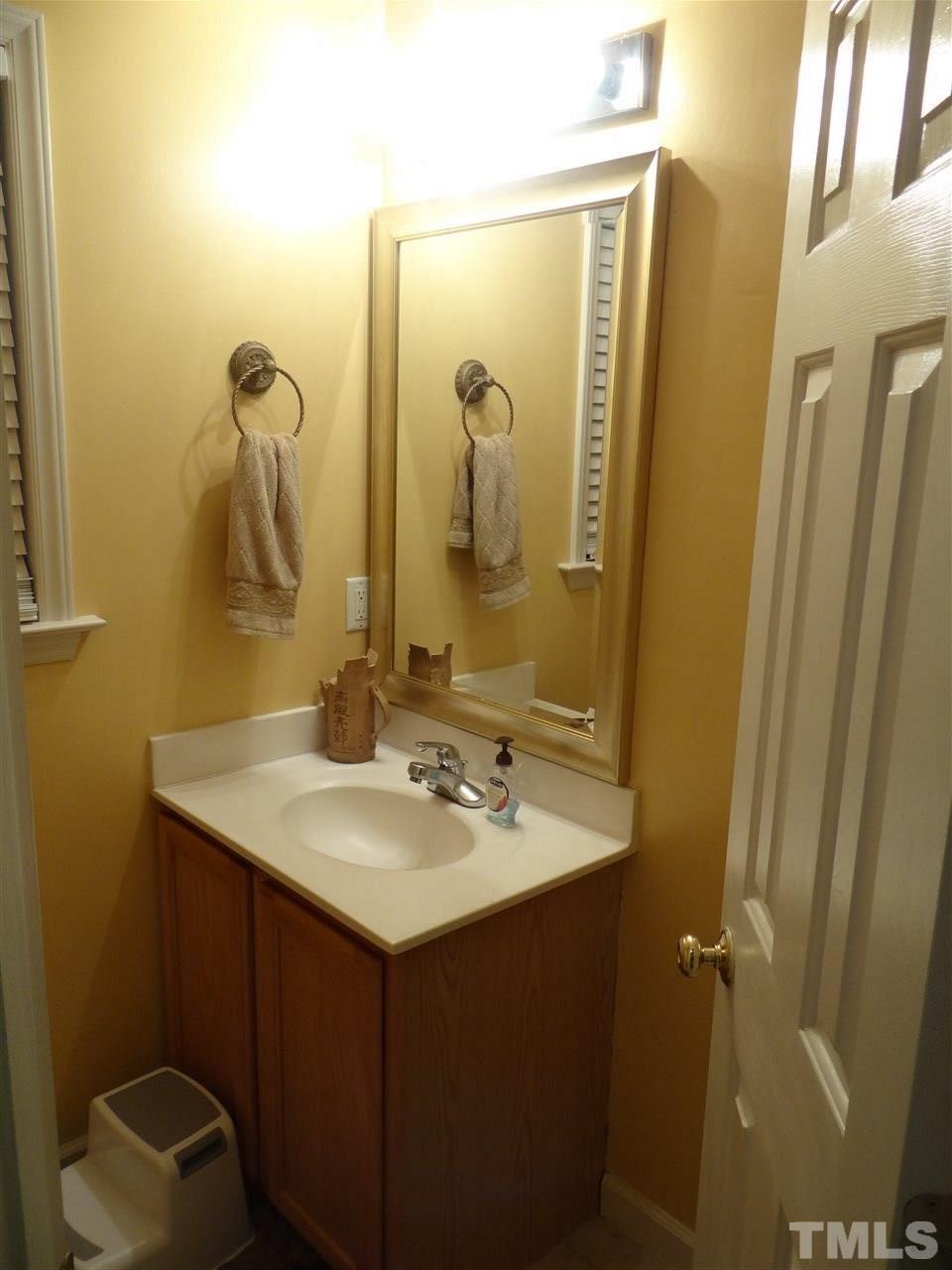 4208 Wolftrap Road Raleigh, NC 27616 - Photo 10 of 23 a bathroom with a sink vanity and mirror