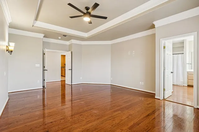 a view of an empty room with wooden floor