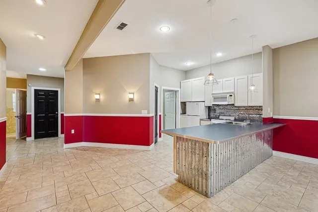 a kitchen with stainless steel appliances kitchen island granite countertop a stove and cabinets