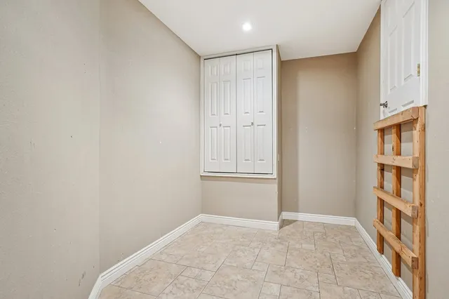 a bathroom with a granite countertop toilet sink and mirror