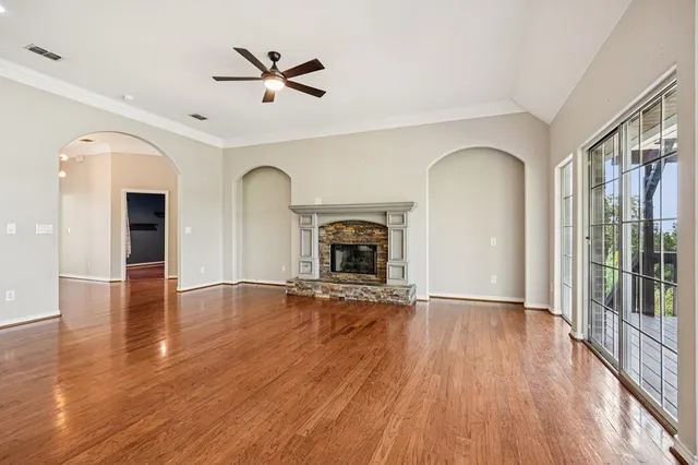 wooden floor in an empty room with a fireplace