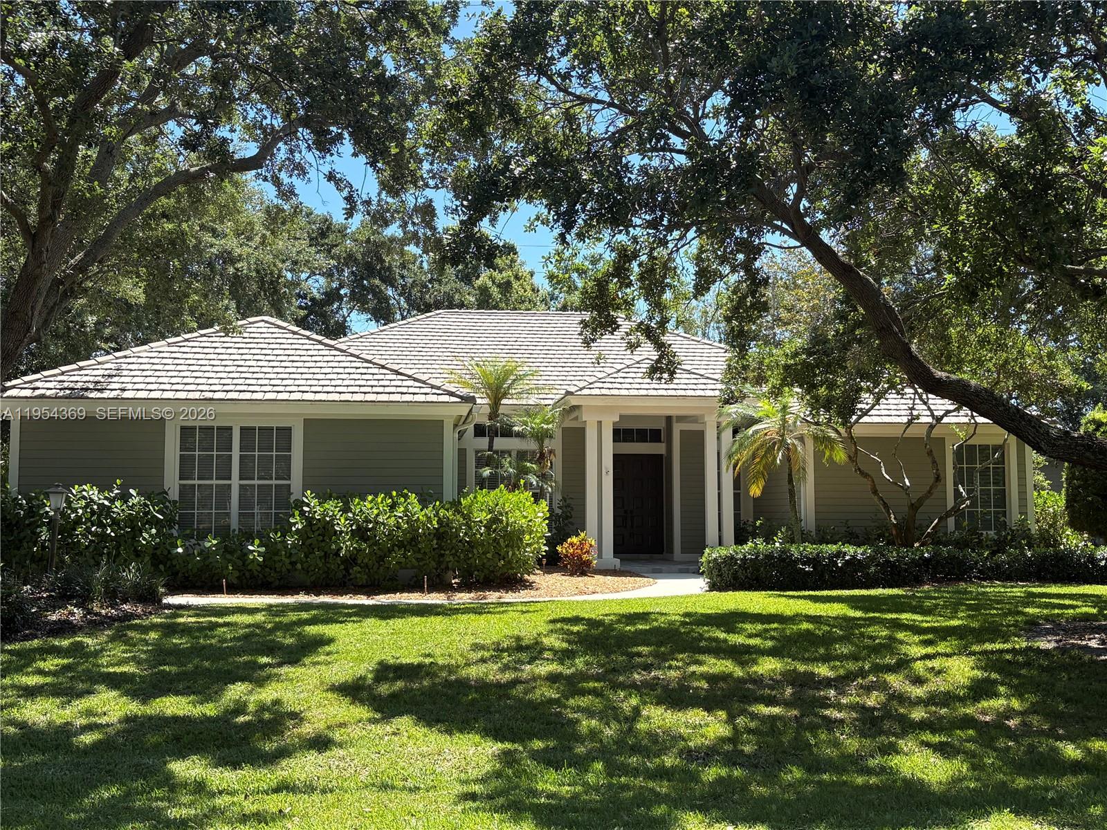 18265 Southeast Ridgeview Drive Tequesta, FL 33469 - Photo 15 of 15 a front view of a house with garden