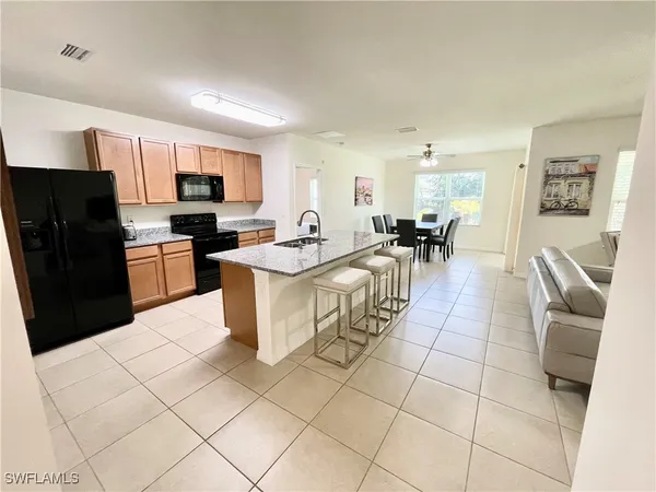 a large white kitchen with a large window
