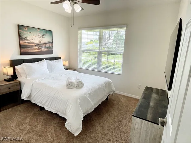 a bed sitting in a bedroom next to a window