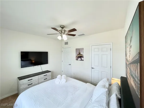 a bedroom with a bed and a flat screen tv