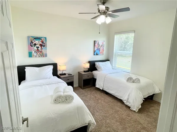 a spacious bedroom with a bed and a window