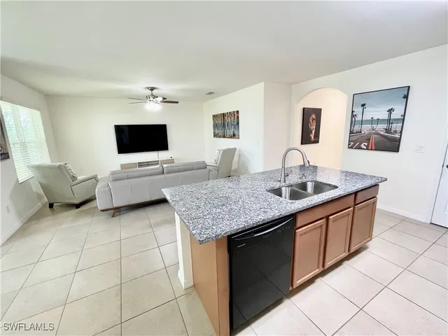 a living room with granite countertop furniture and fireplace